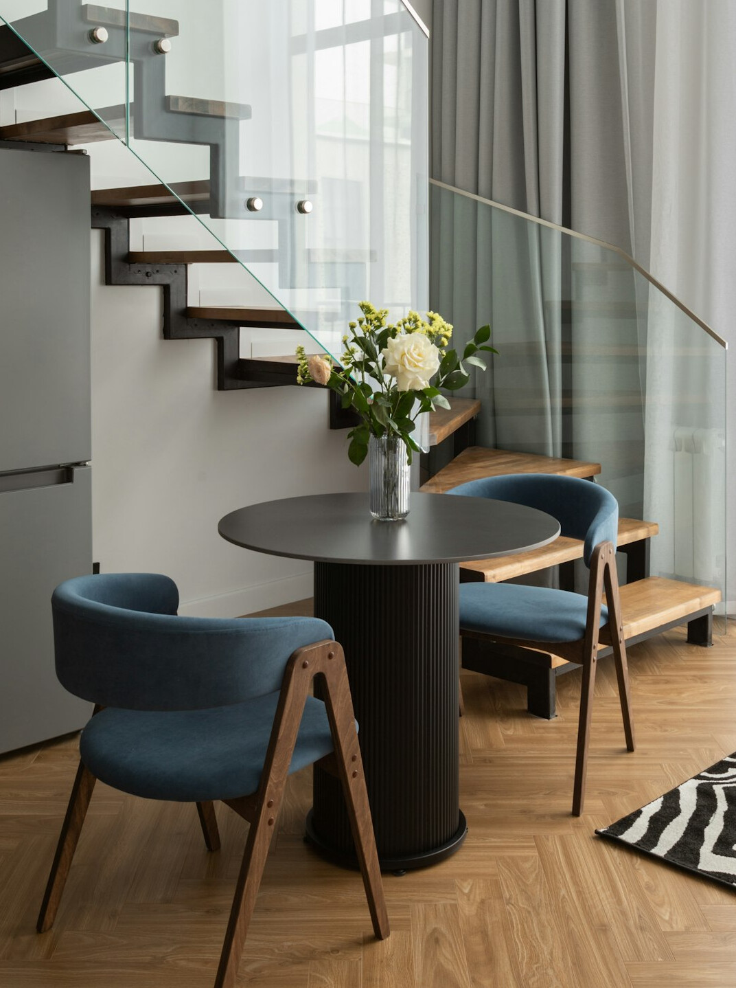 Bright apartment living area with storage furniture and a laptop on a table