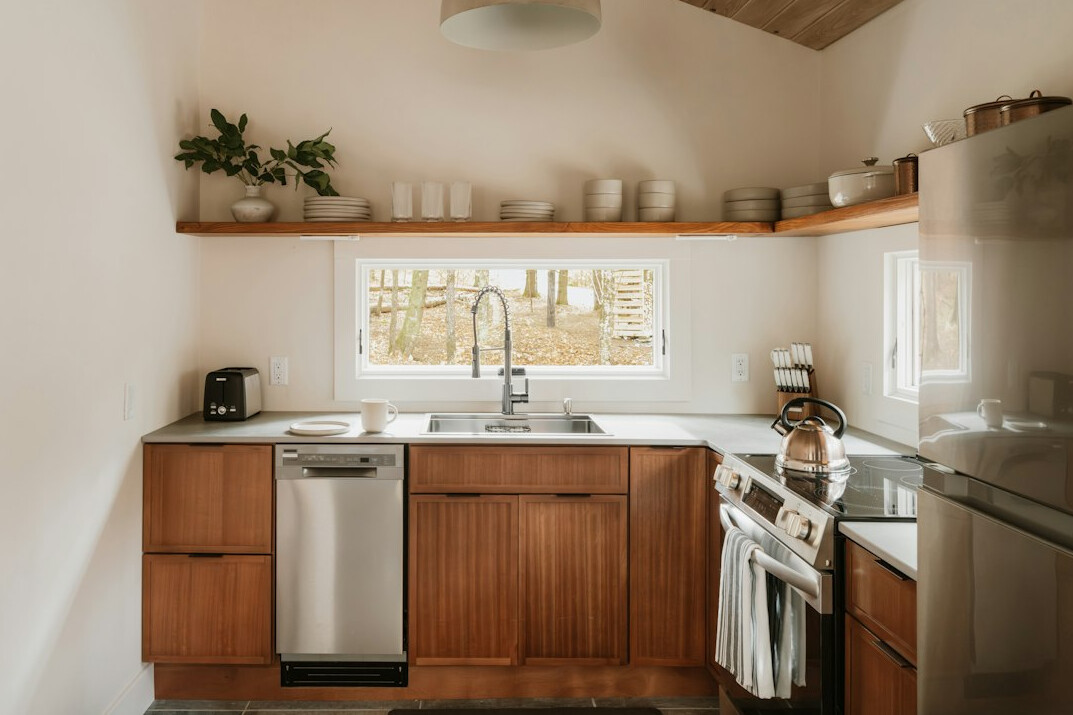 Bright home kitchen with wooden shelves and neatly arranged jars