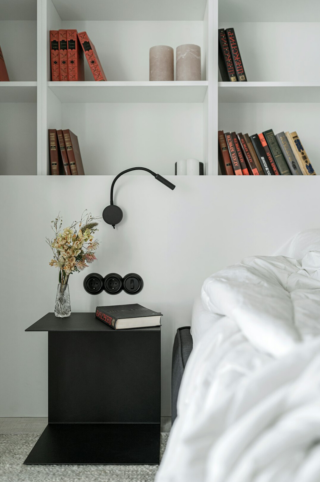 Small bedroom with bed, bedside table and tidy shelf