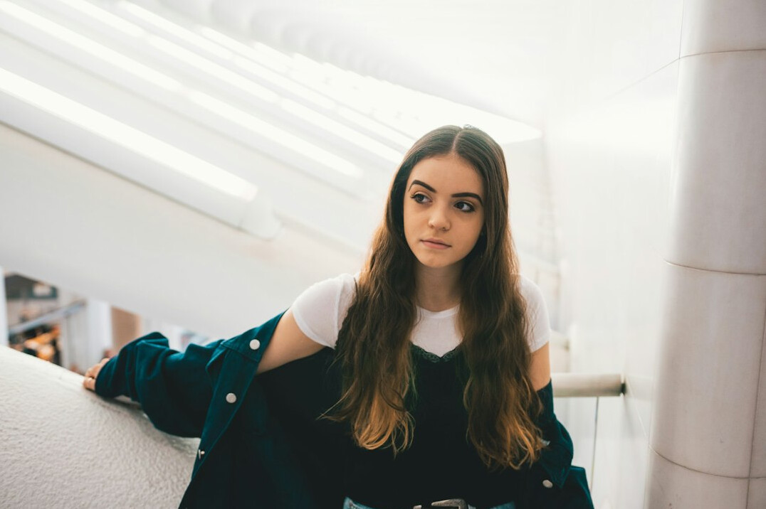Portrait of a young woman with long hair looking at the camera