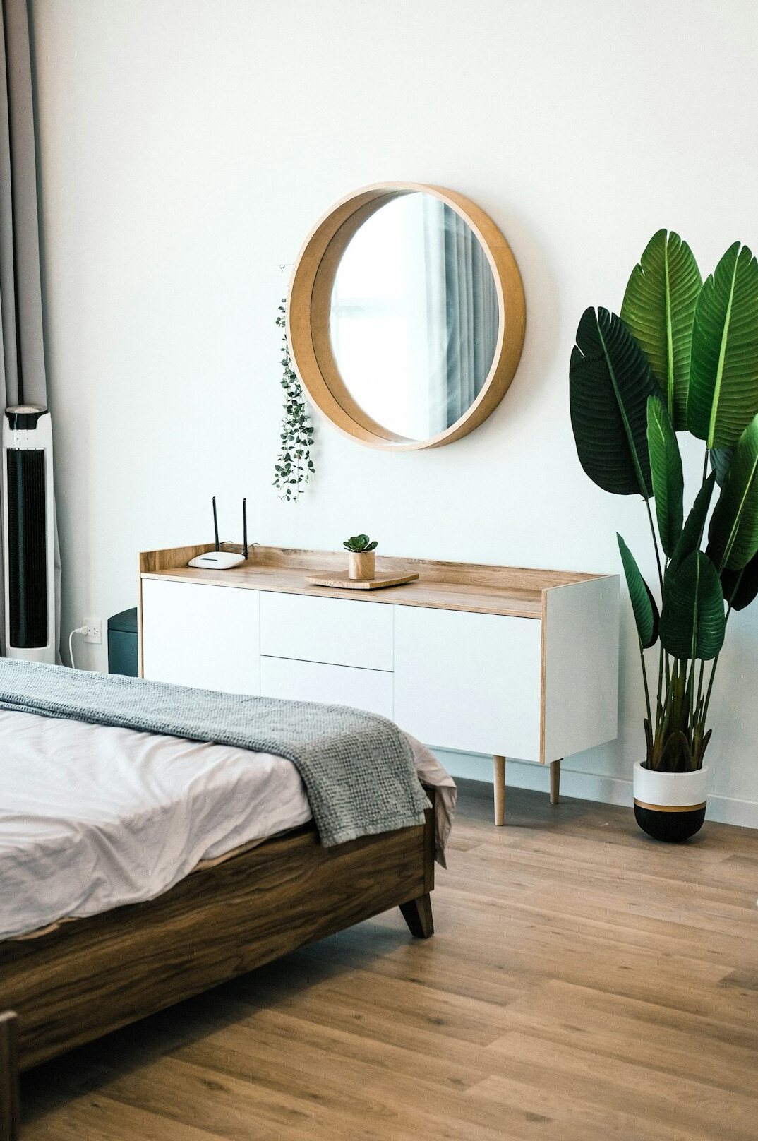 Bright apartment interior with light wood furniture and plants