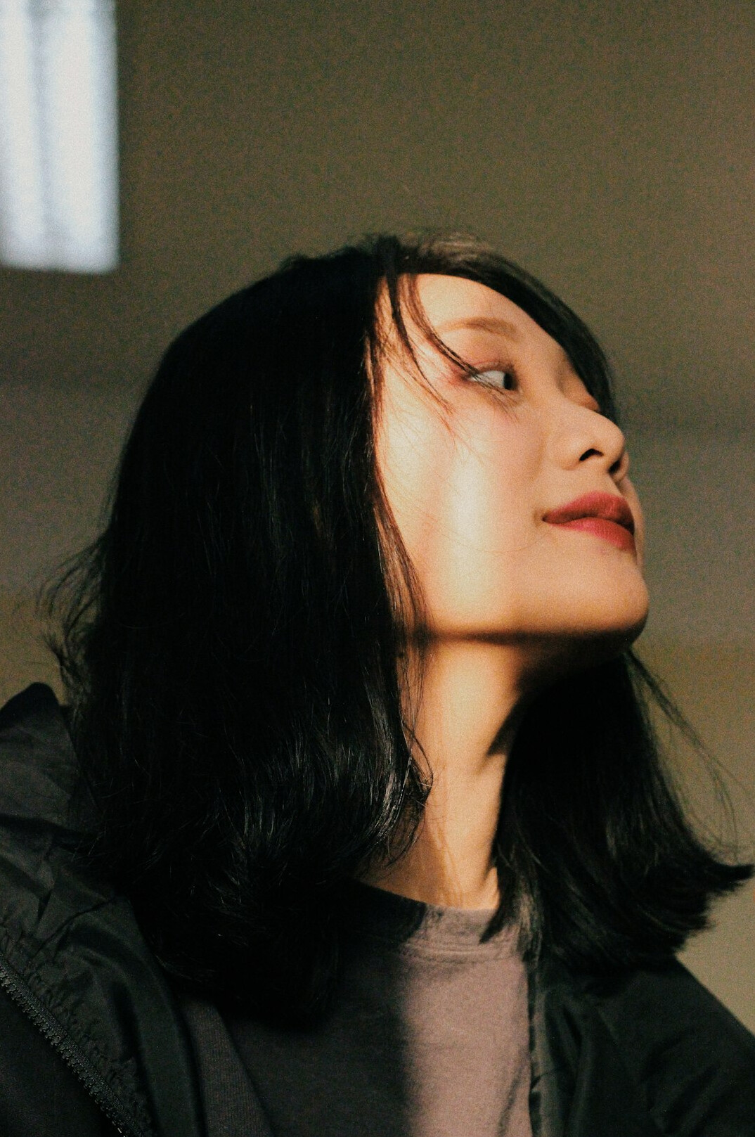 Portrait of a woman with dark hair and a warm smile