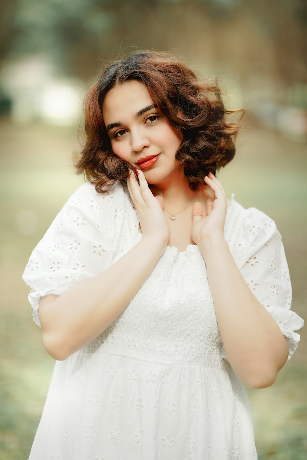 Portrait of a woman with wavy hair and a gentle smile