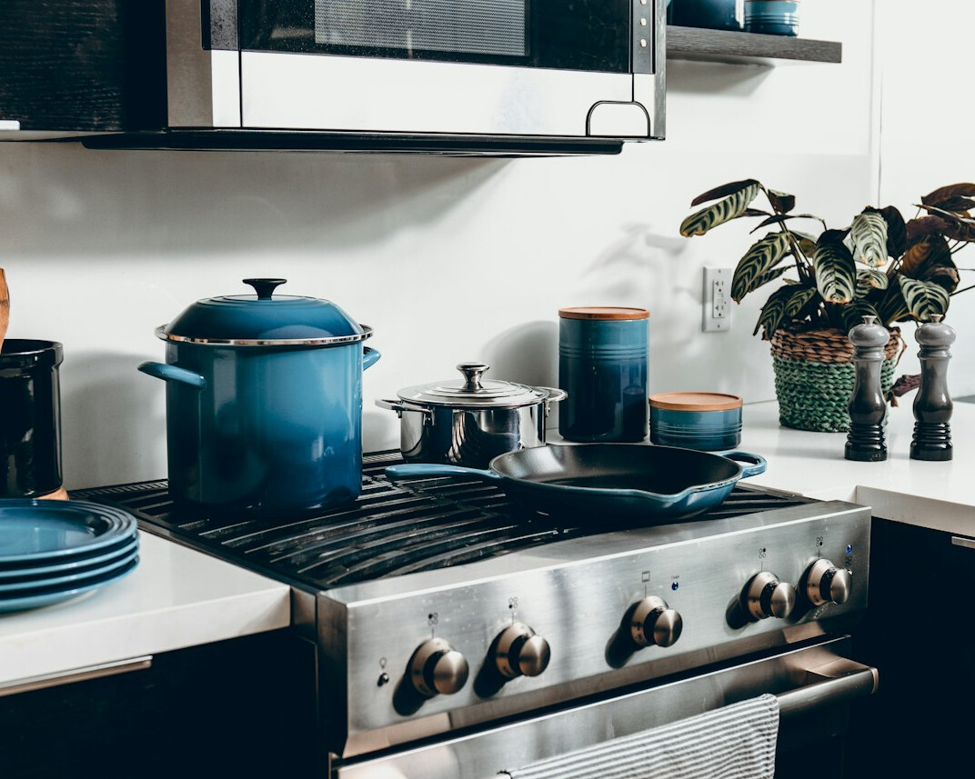 Kitchen counter with utensils and containers arranged by the stove